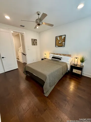 a spacious bedroom with a bed and a chandelier