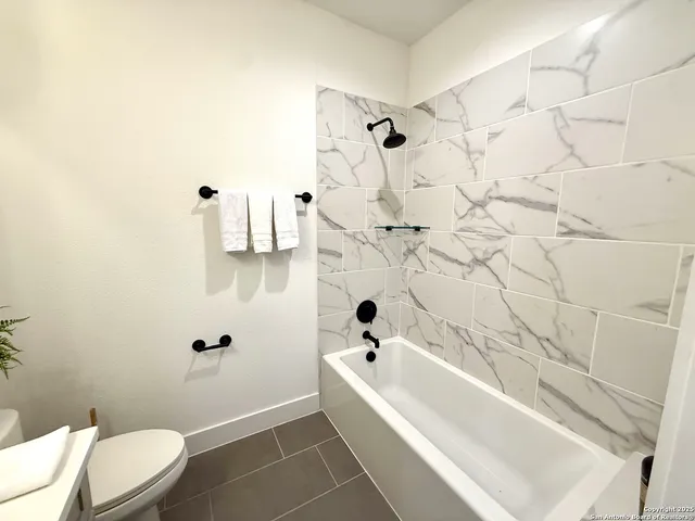 a bathroom with a bathtub and toilet