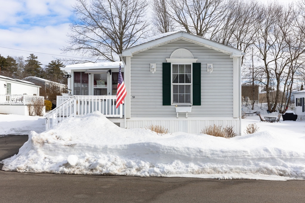 51 Tucker Terrace Raynham, MA 02767 - Photo 1 of 35 a front view of a house with a yard covered in snow