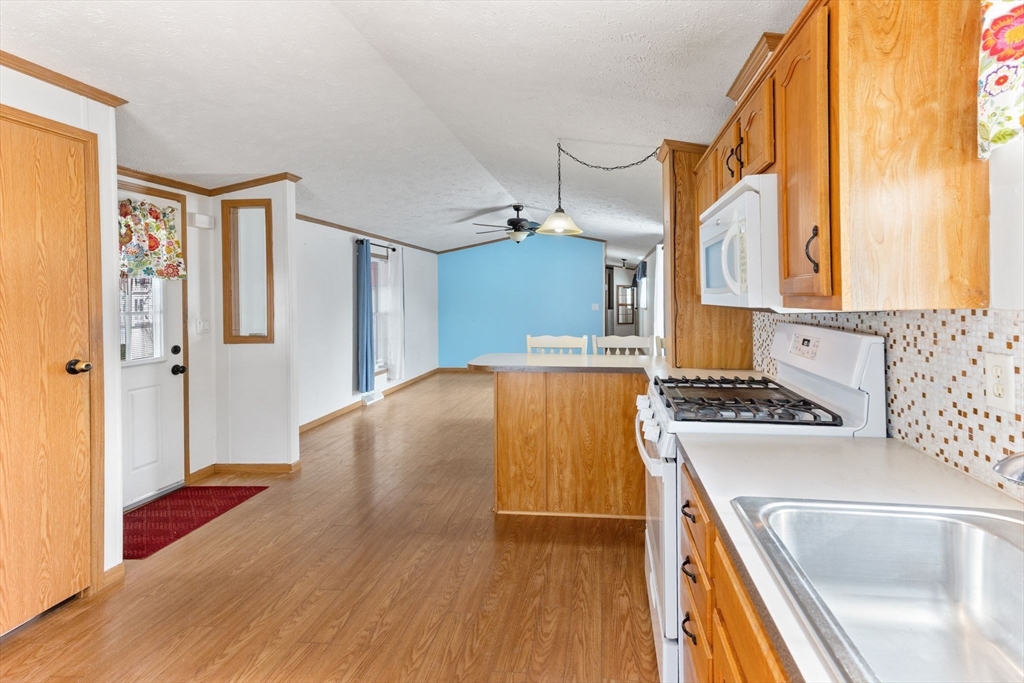51 Tucker Terrace Raynham, MA 02767 - Photo 19 of 35 a kitchen with a refrigerator and a stove