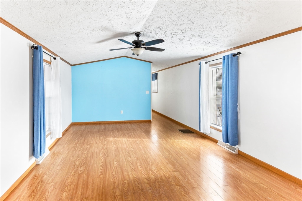 51 Tucker Terrace Raynham, MA 02767 - Photo 20 of 35 a view of a big room with wooden floor staircase and windows