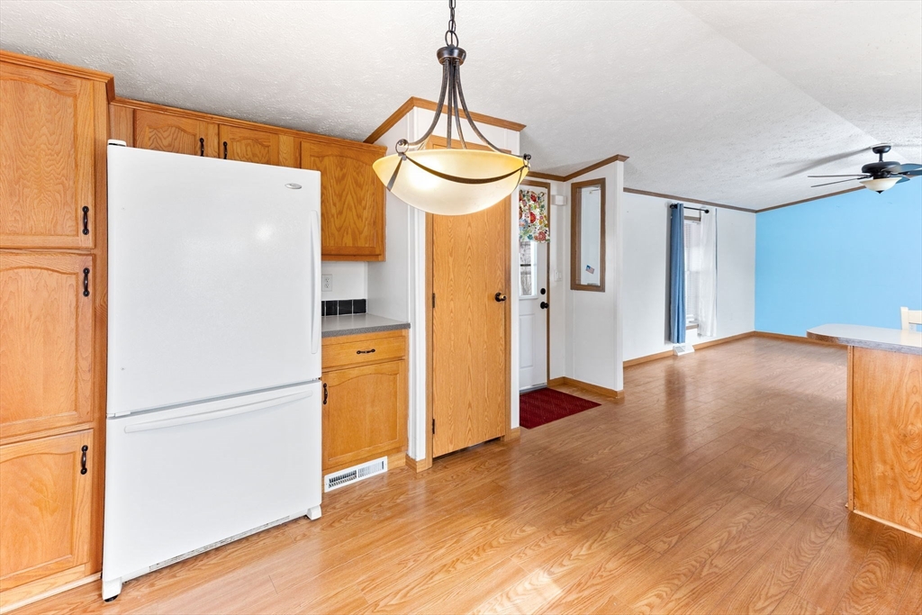 51 Tucker Terrace Raynham, MA 02767 - Photo 21 of 35 a bedroom with a bed and a chandelier