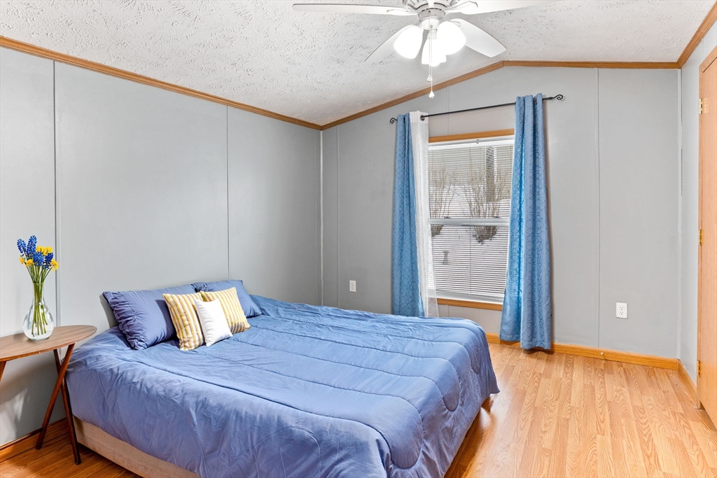 51 Tucker Terrace Raynham, MA 02767 - Photo 23 of 35 a bedroom with a bed and a chandelier