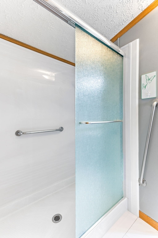 51 Tucker Terrace Raynham, MA 02767 - Photo 25 of 35 a bathroom with a glass shower door