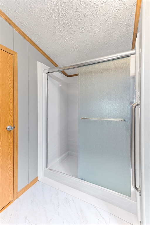 51 Tucker Terrace Raynham, MA 02767 - Photo 26 of 35 a bathroom with a glass shower door