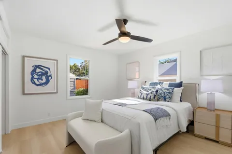 a bedroom with a bed and a painting on the wall