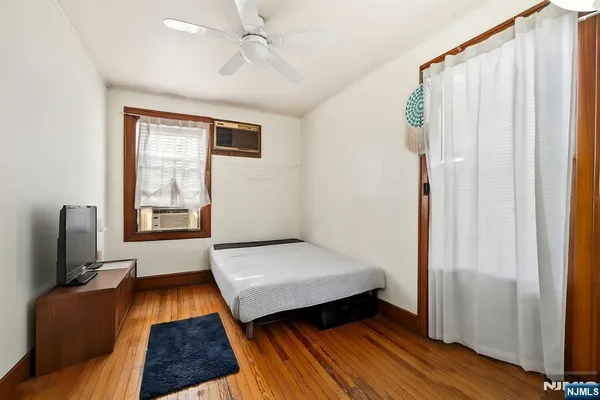 a bedroom with furniture and a window