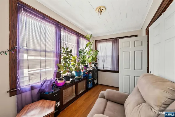 a bedroom with a bed couch and a window