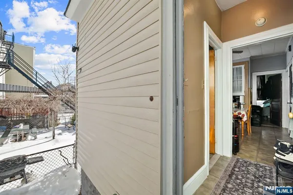 a view of a hallway with a livingroom and dining room view
