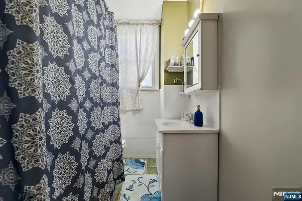 a kitchen with a refrigerator a stove a sink a dining table and chairs