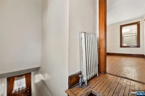 a view of a livingroom with wooden floor and a window
