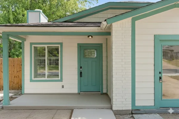 a view of a white house with a sign broad