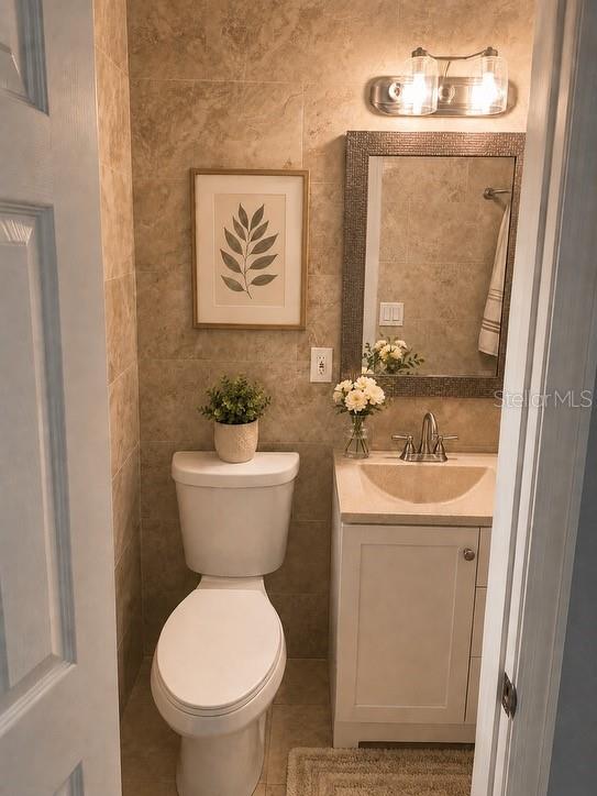 1623 Wavecrest Street Merritt Island, FL 32952 - Photo 11 of 26 a bathroom with a toilet sink and mirror