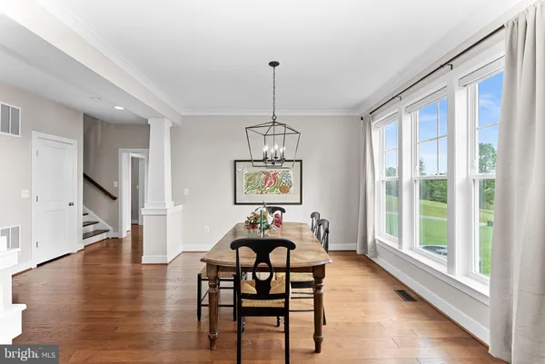 a living room with furniture fireplace and a large window