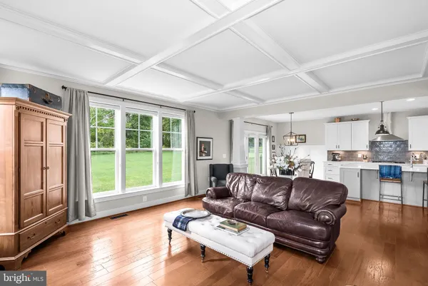 a large kitchen with kitchen island stainless steel appliances and wooden floor