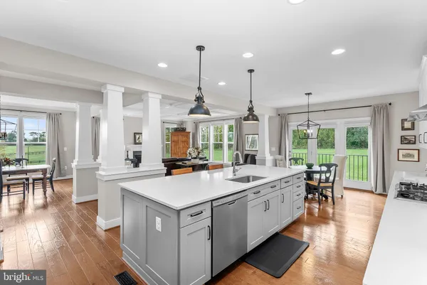 a kitchen with stainless steel appliances granite countertop a sink a stove and a refrigerator