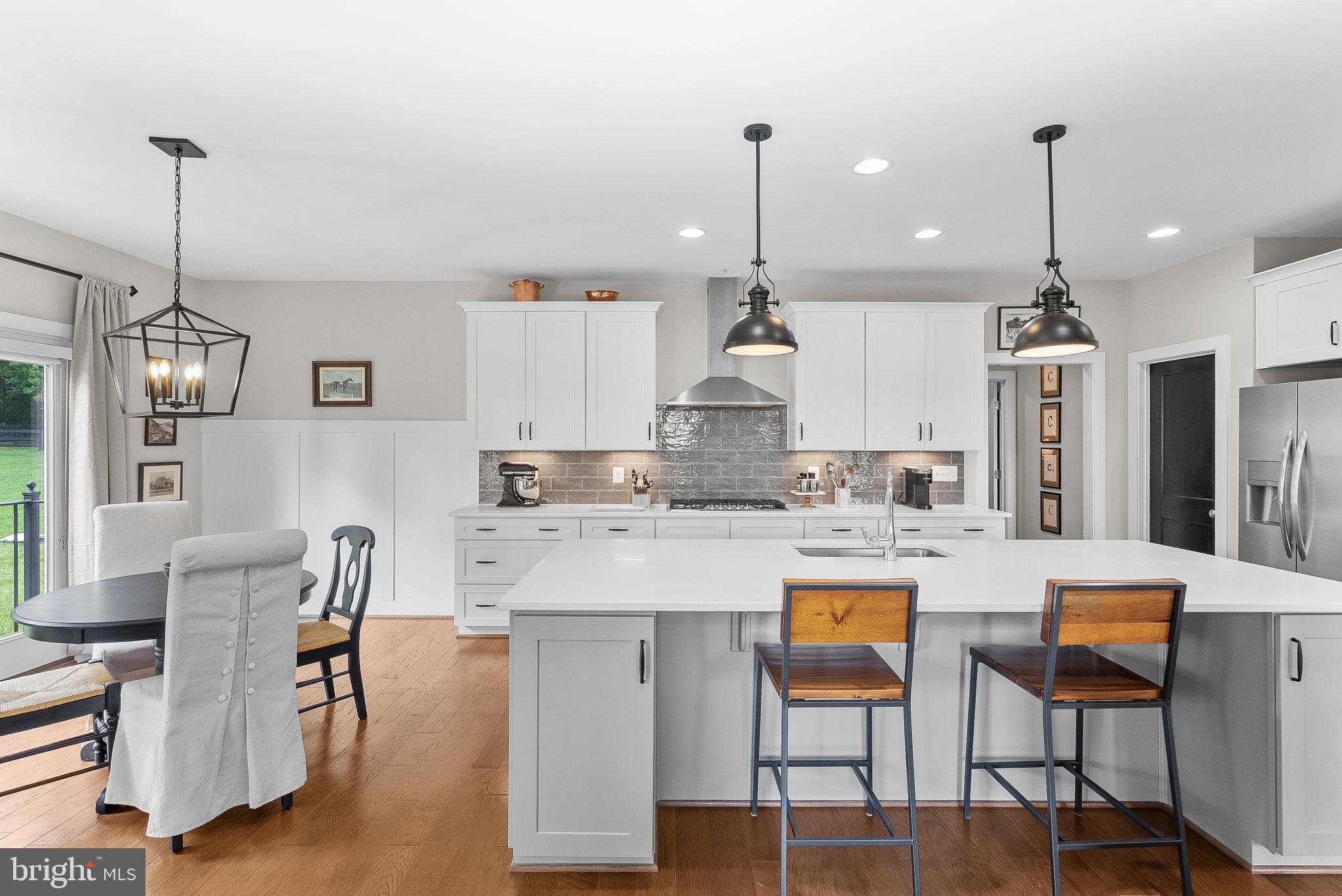 38147 Touchstone Farm Lane Hamilton, VA 20158 - Photo 19 of 71 a large kitchen with kitchen island stainless steel appliances and wooden floor