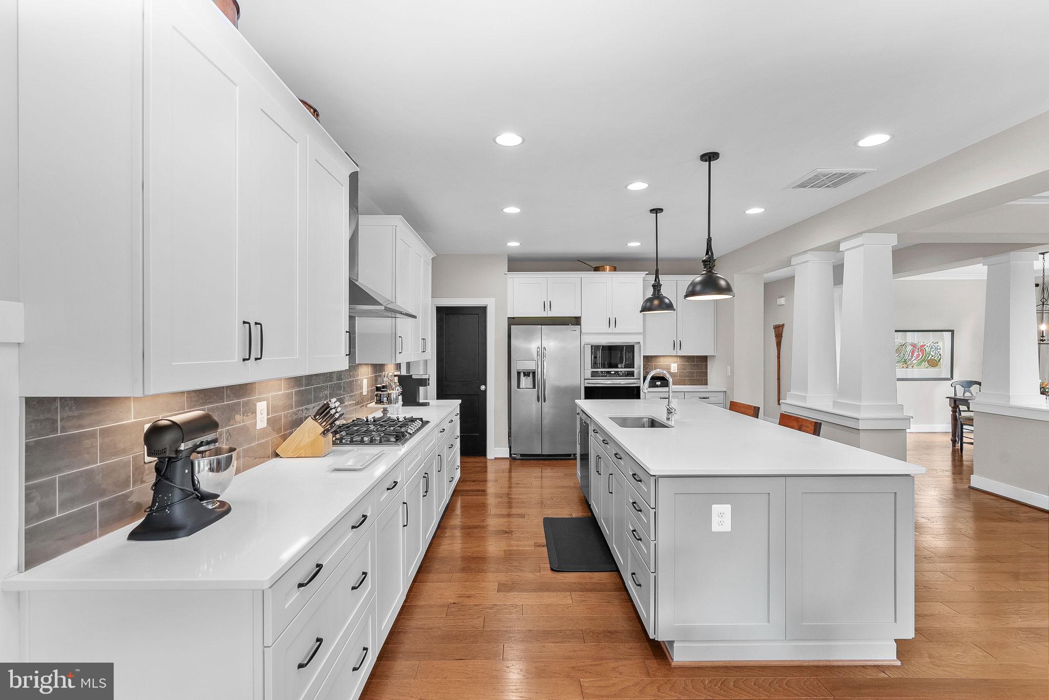 38147 Touchstone Farm Lane Hamilton, VA 20158 - Photo 21 of 71 a kitchen with stainless steel appliances a sink a stove top oven a counter space and cabinets