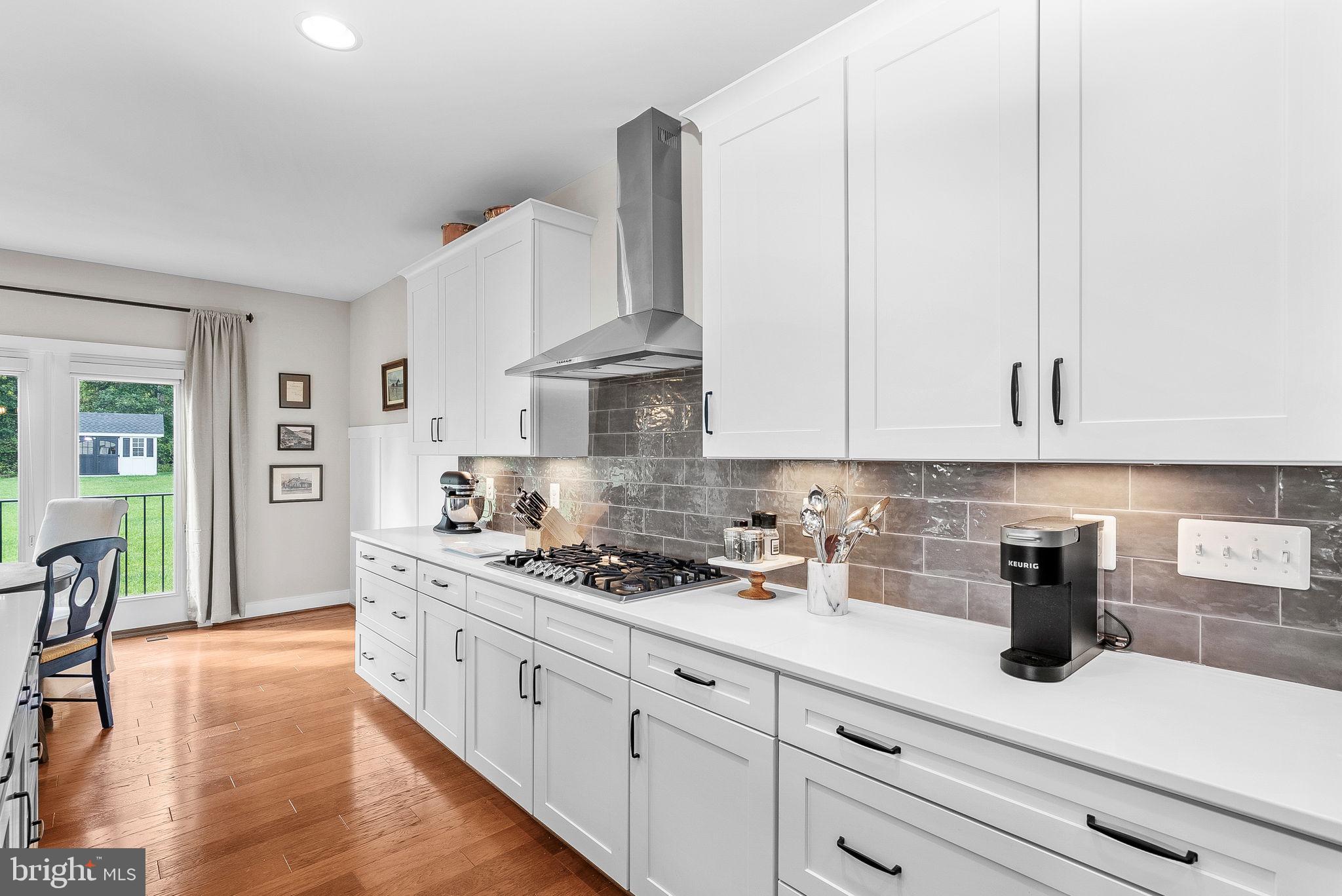 38147 Touchstone Farm Lane Hamilton, VA 20158 - Photo 24 of 71 a kitchen with stainless steel appliances white cabinets a stove a sink and white cabinets