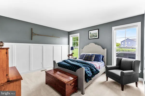 a view of a hallway with wooden floor and stairs