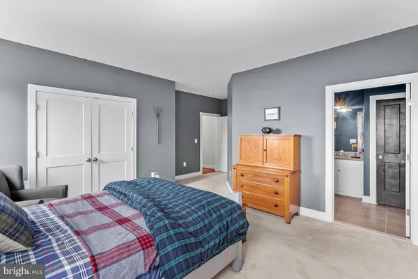 a bedroom with a bed and a couch