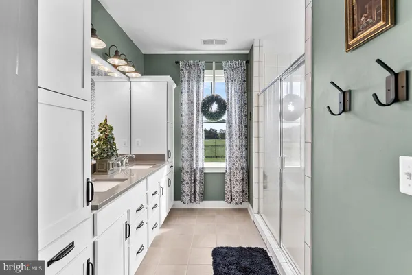a bathroom with a sink a toilet and shower curtain