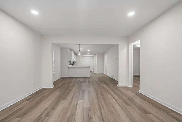 a view of a room with wooden floor and window