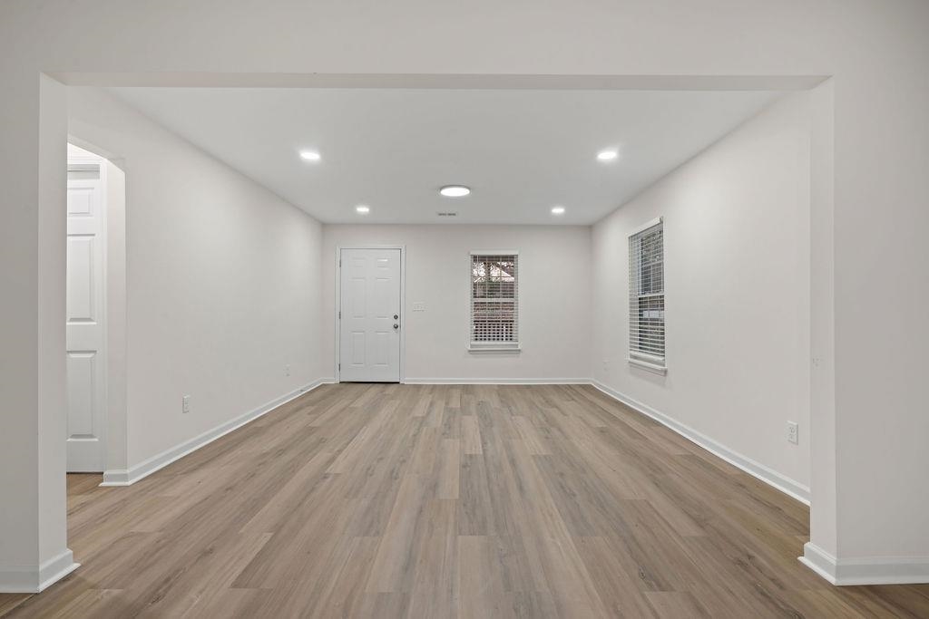 2859 Carnes Avenue Memphis, TN 38114 - Photo 5 of 14 a view of an empty room with wooden floor and a window