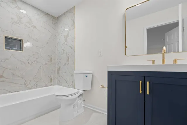 a bathroom with a toilet a sink and bathtub