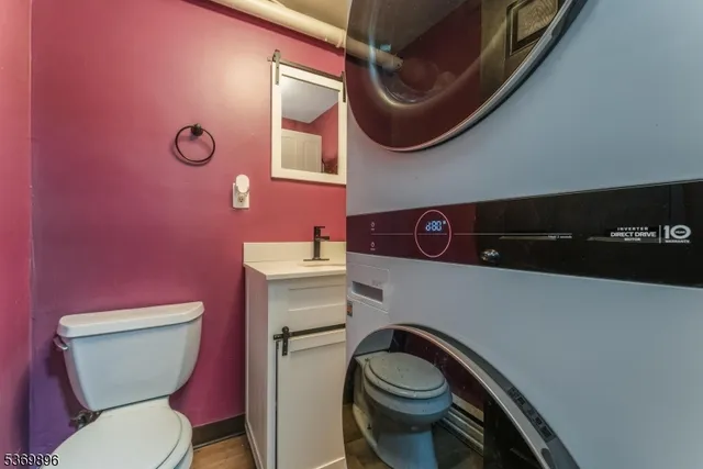 a bathroom with a toilet a sink and mirror