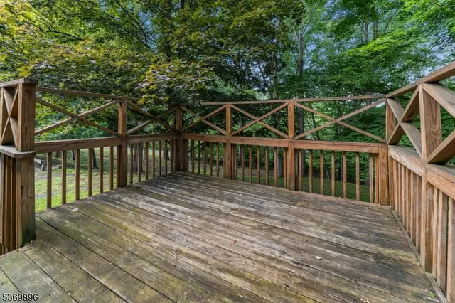 a view of a house with backyard and deck