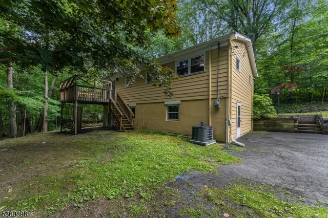 a view of a house with backyard and a tree