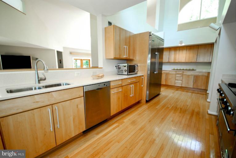 11576 Lake Newport Road Reston, VA 20194 - Photo 16 of 30 a large kitchen with cabinets and wooden floor