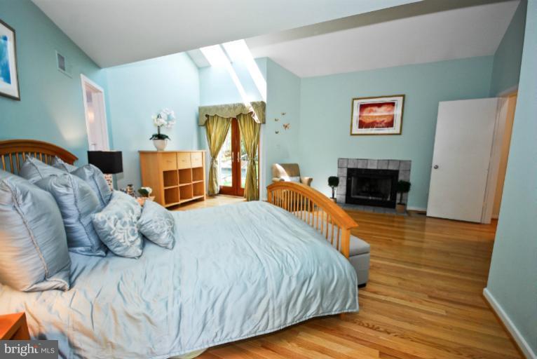 11576 Lake Newport Road Reston, VA 20194 - Photo 19 of 30 a bedroom with a bed and wooden floor