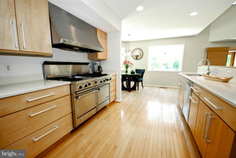 11576 Lake Newport Road Reston, VA 20194 - Photo 4 of 30 a kitchen with stainless steel appliances a stove sink microwave and cabinets