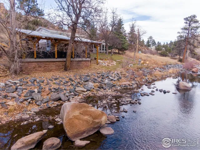 a view of a house with a yard balcony and sitting area