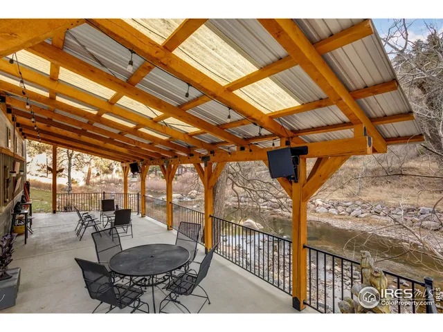 a view of a patio with a table and chairs