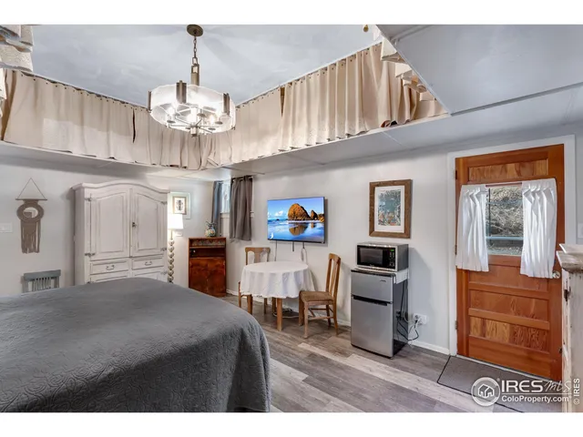 a bedroom with furniture and a chandelier