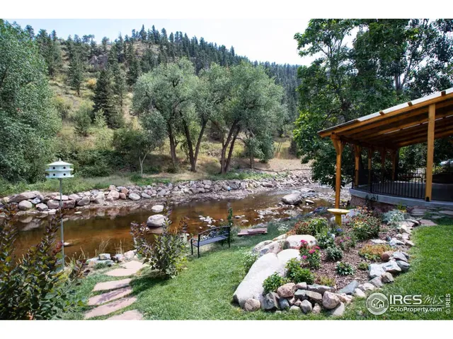 a view of residential houses with yard and ocean view