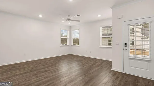 wooden floor in an empty room with a window