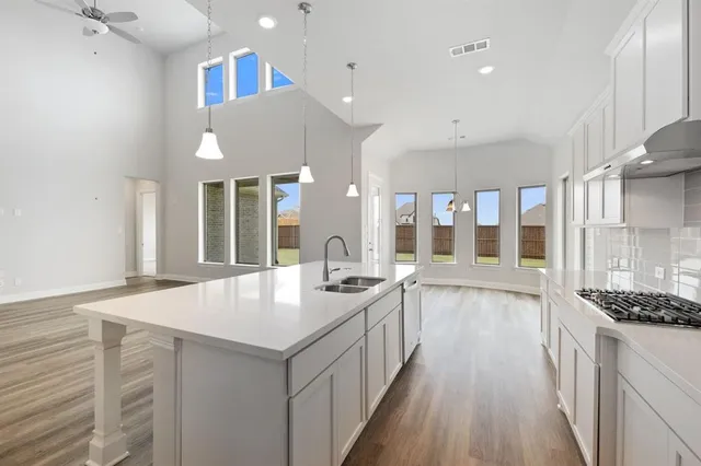 a large white kitchen with a large window