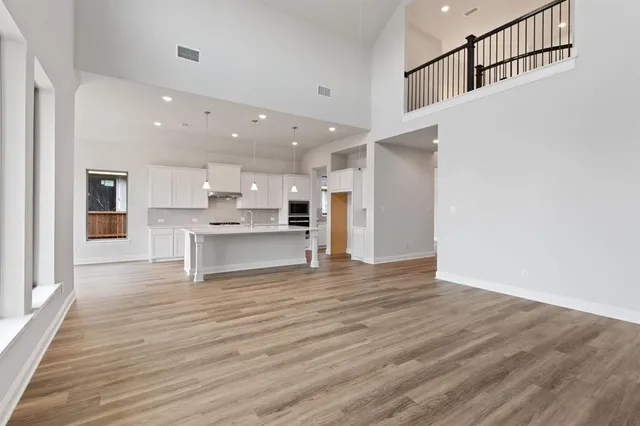 a view of kitchen with kitchen island microwave and stove