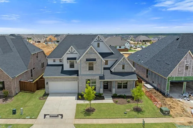 aerial view of a house with a yard
