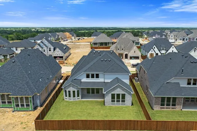 an aerial view of a house with a yard