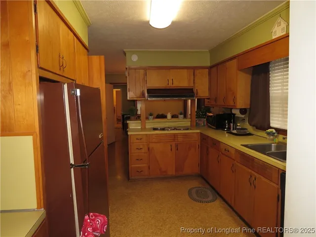 a kitchen with a refrigerator sink and stove