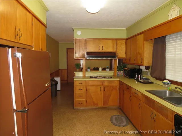 a kitchen with a refrigerator and a sink