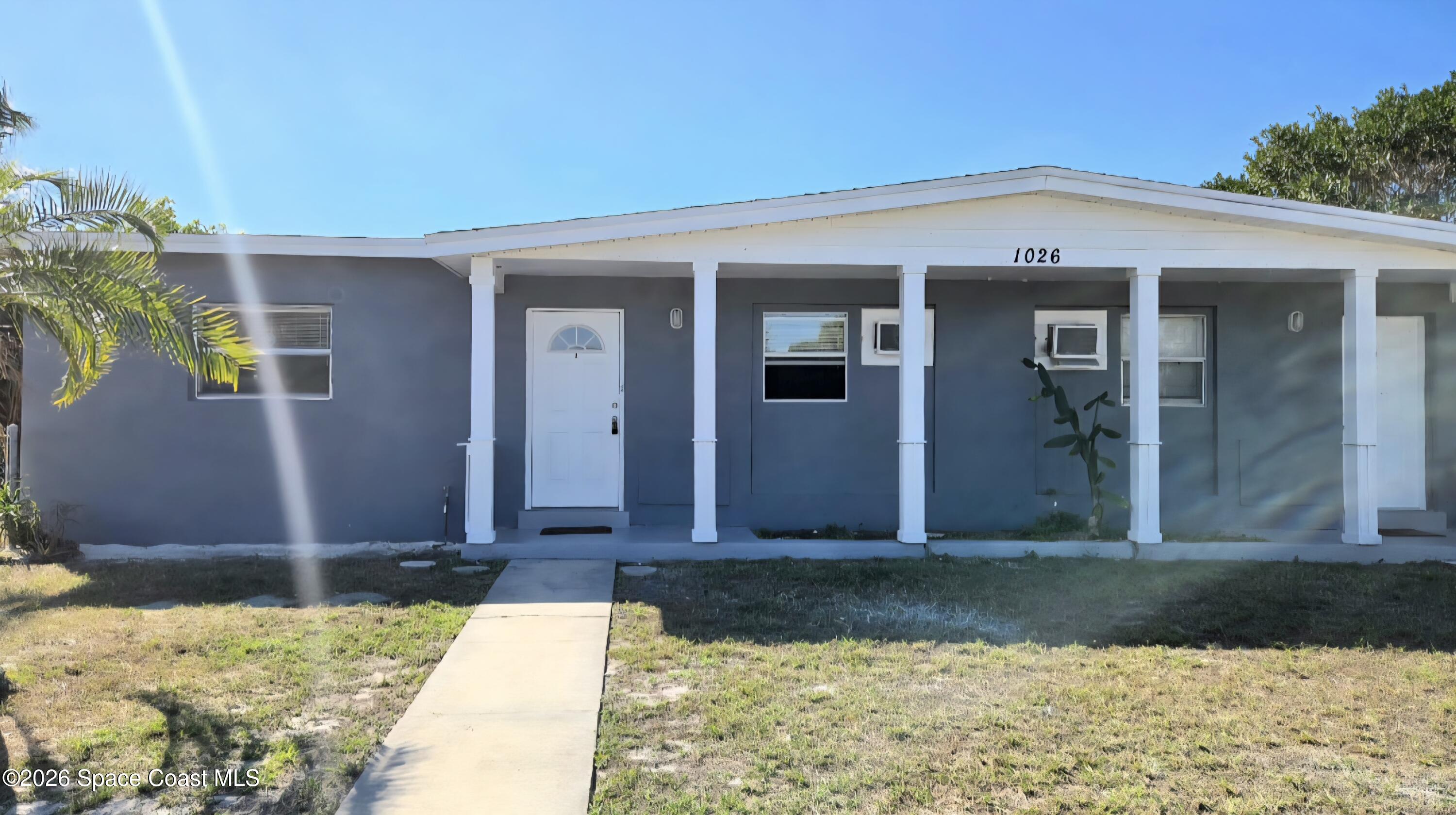 1026 Bacon Circle Northeast, Unit A Palm Bay, FL 32905 - Photo 1 of 12 a front view of a house