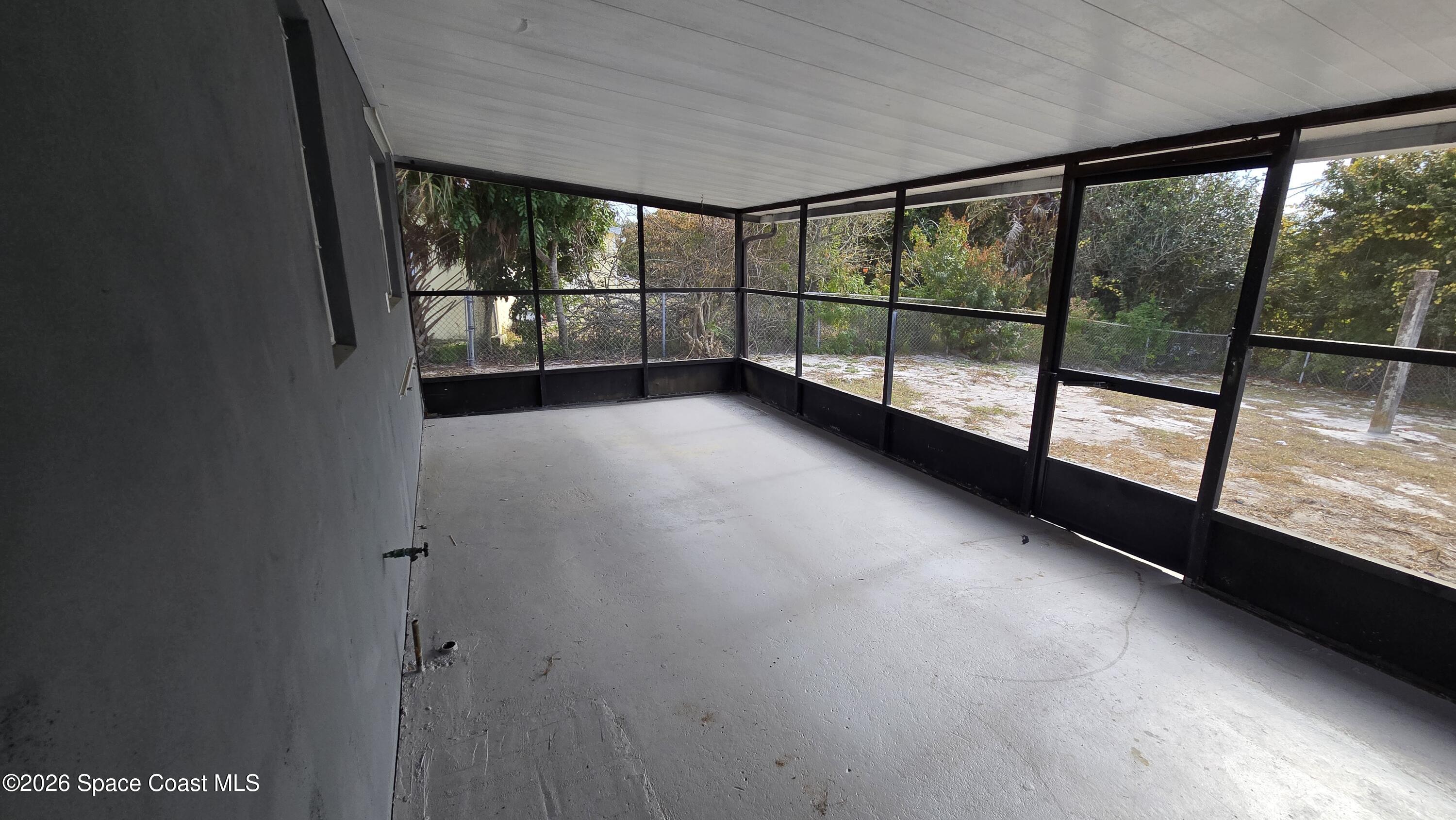 1026 Bacon Circle Northeast, Unit A Palm Bay, FL 32905 - Photo 11 of 12 a view of an empty room with a large window