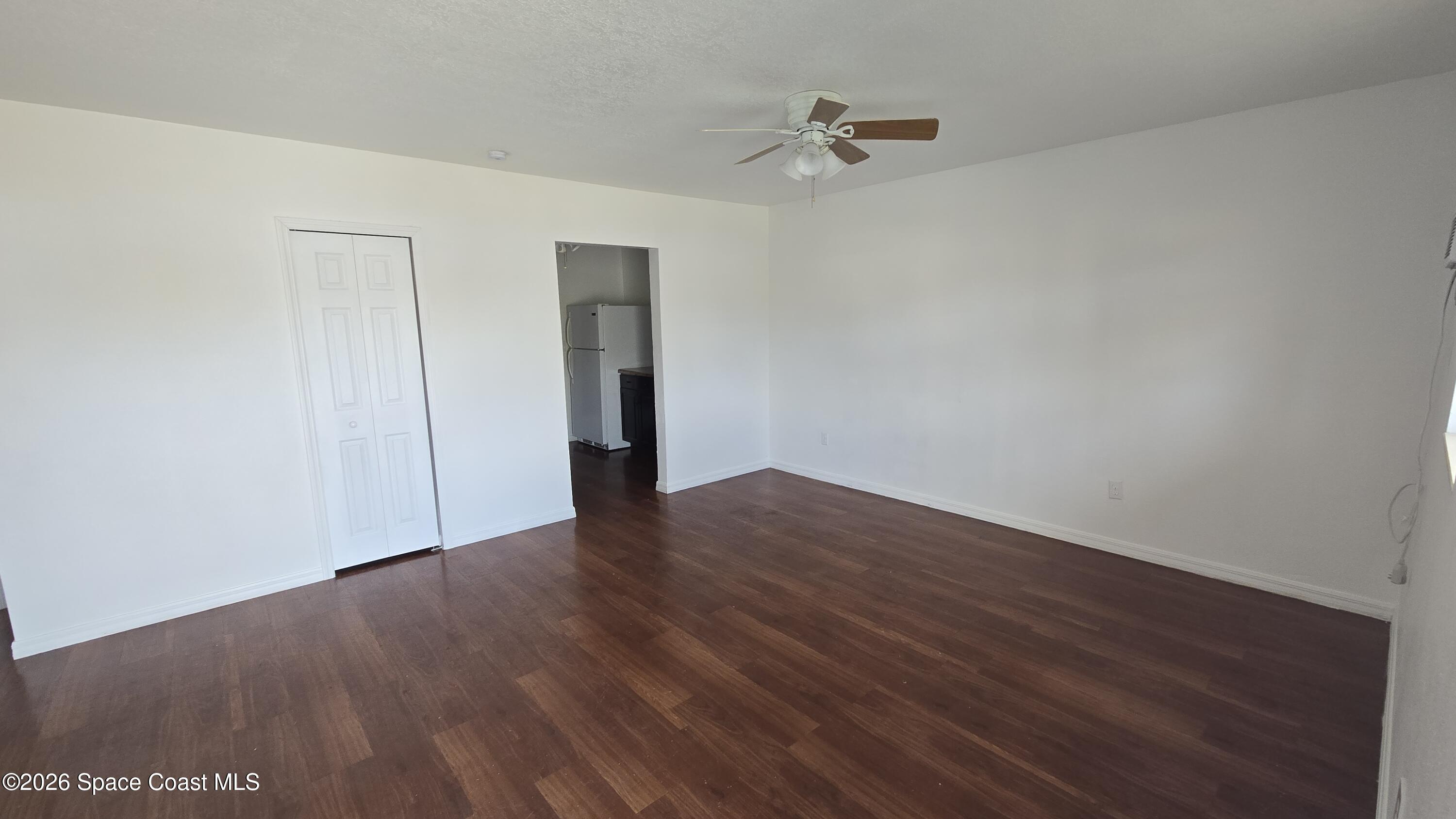 1026 Bacon Circle Northeast, Unit A Palm Bay, FL 32905 - Photo 2 of 12 a view of an empty room with wooden floor