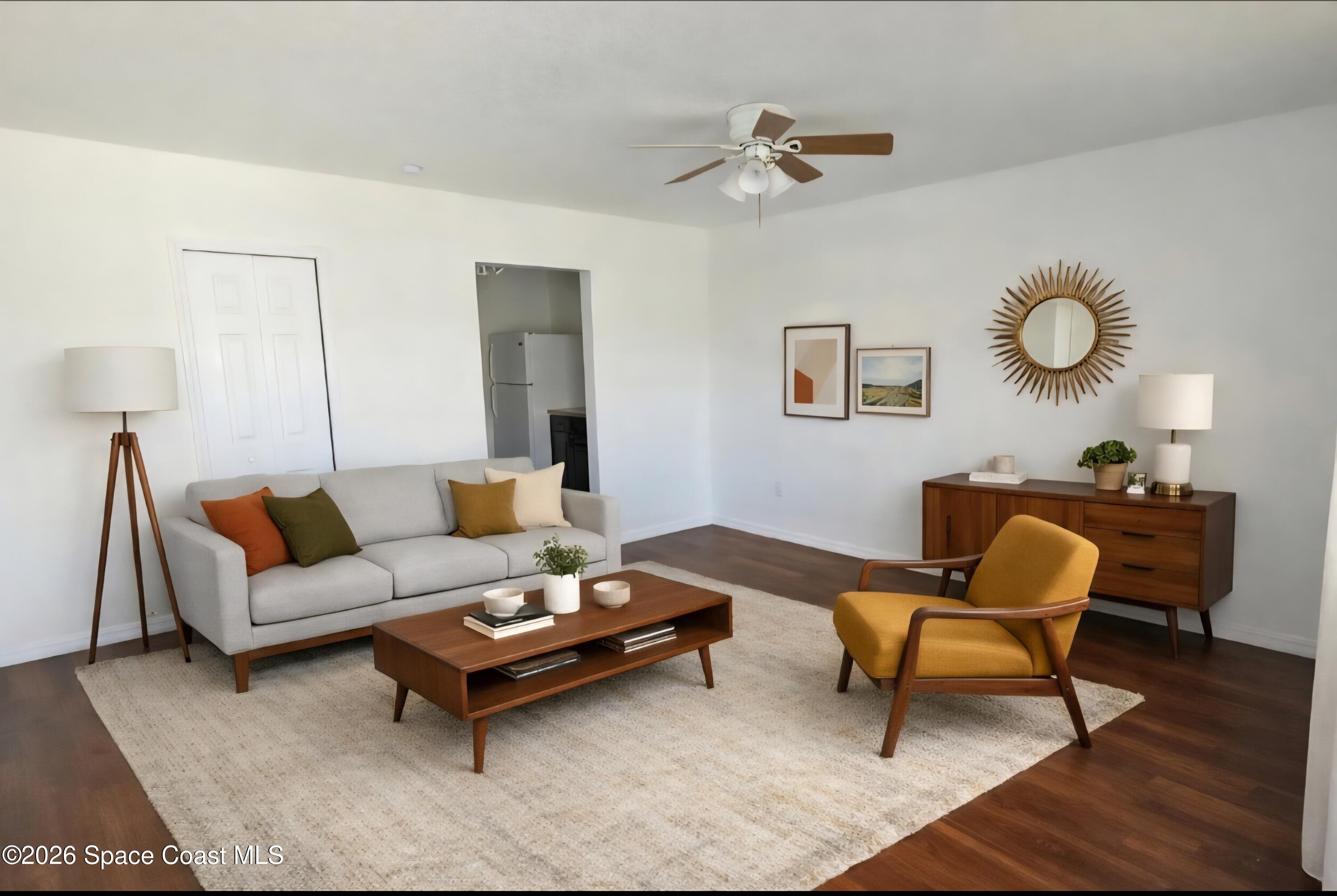 1026 Bacon Circle Northeast, Unit A Palm Bay, FL 32905 - Photo 3 of 12 a living room with furniture and wooden floor